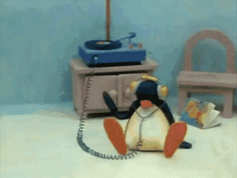 a stuffed penguin wearing headphones and a stethoscope is sitting on the floor .