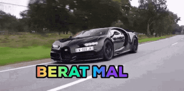 a black sports car is driving down a road with the words berat mal written on the bottom