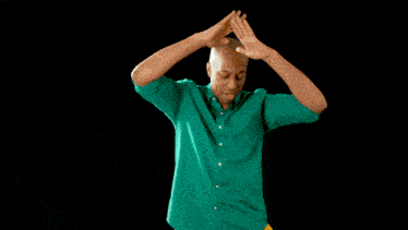 a man in a green shirt and a woman in a yellow shirt are dancing