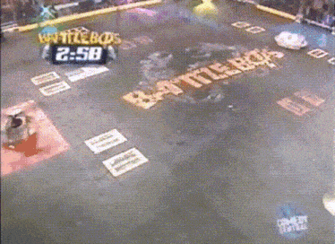 a robot is being destroyed by another robot in a battlebots game .