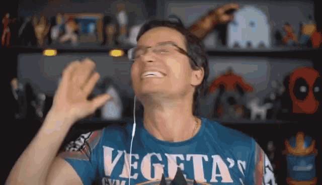 a man wearing a blue shirt that says vegeta 's