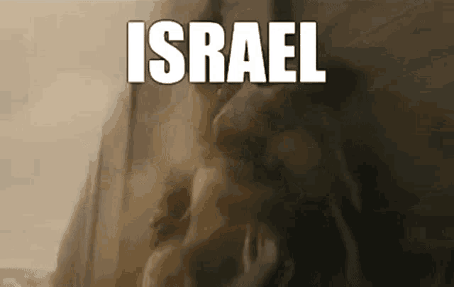 a group of people standing in front of a wall with the word israel on it