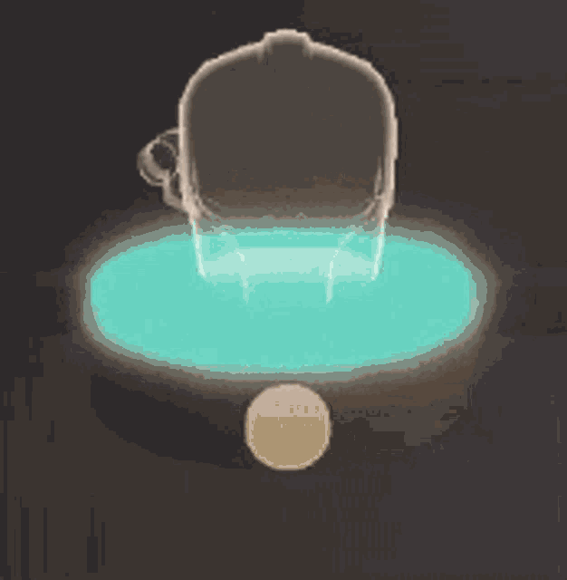a statue of a skull is sitting on top of a glowing blue circle .