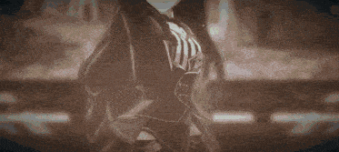 a blurred image of a girl with long black hair and a bow tie