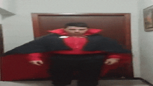 a blurry picture of a man in a red and black costume