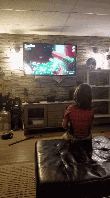 two children are sitting in front of a television playing a game called dragon quest