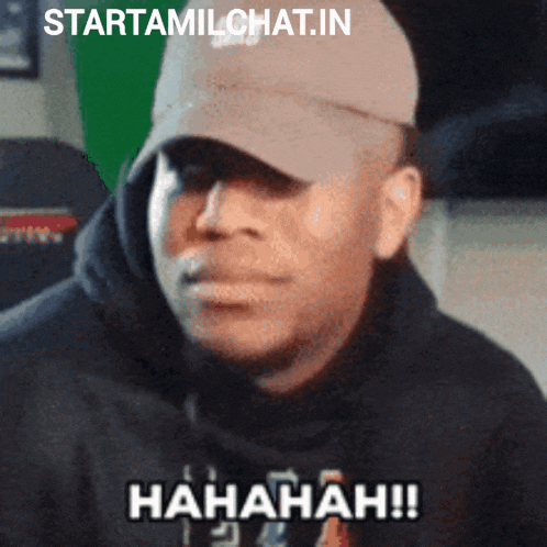 a man wearing a baseball cap and a black hoodie says ' hahahaha ' on the bottom