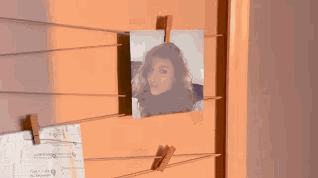 a picture of a woman hangs on a clothes line