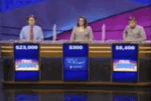 a group of people sitting at a table with a sign that says $ 25,000