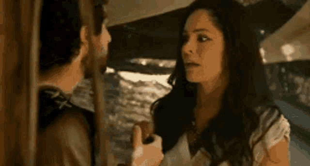 a man and a woman are standing next to each other in a room .