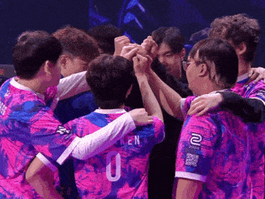 a group of people are huddled together with one wearing a number 0 jersey
