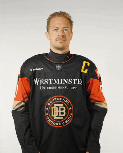 a man wearing a black jersey with the letter c on it