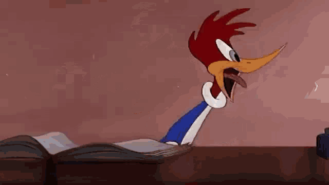 woody woodpecker is a cartoon character that is standing on a table .