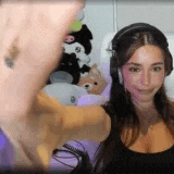 a woman wearing headphones is sitting in front of a computer .