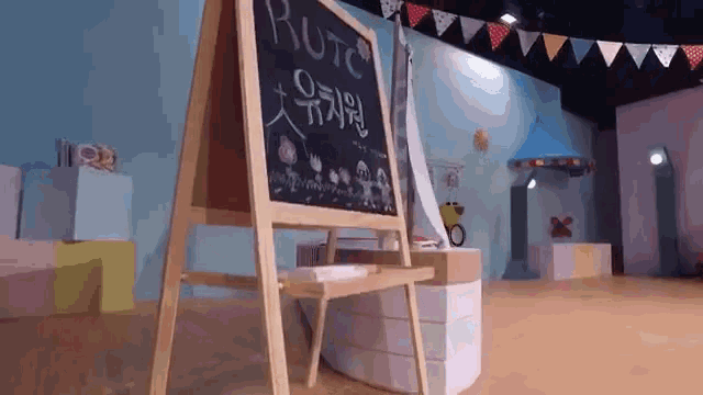 a wooden easel with a blackboard that says rutc