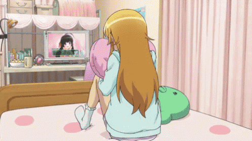 a girl laying on a bed holding a pink pillow