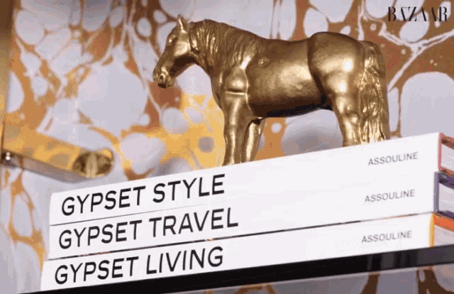 a statue of a horse sits on top of a book titled gypsy style