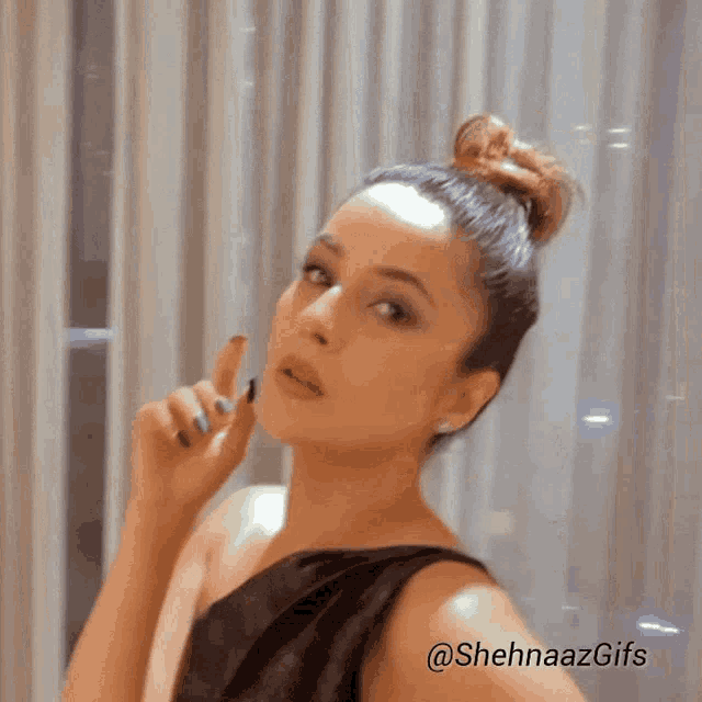 a woman in a black dress is making a funny face with the hashtag @sheenaazgifs