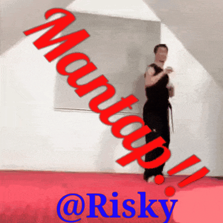 a man standing on a red mat with the words martial arts @risky
