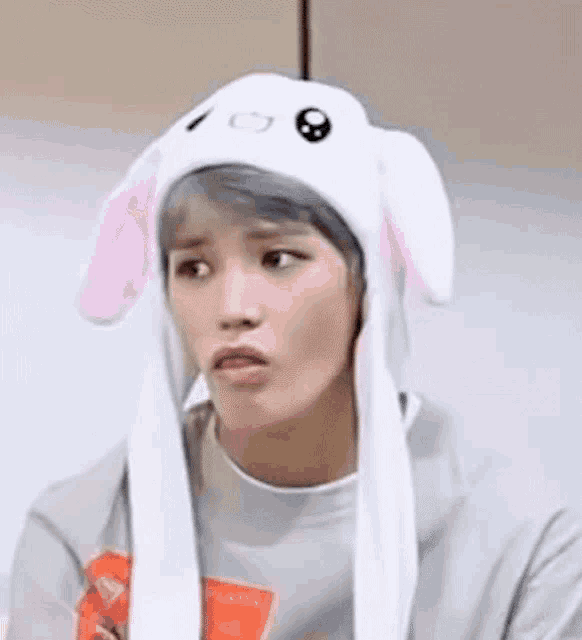 a young man wearing a bunny hat with bunny ears .