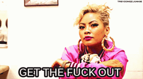 a woman in a pink jacket says get the fuck out in black letters