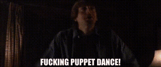 a man is dancing in a dark room and says `` fucking puppet dance ! ''