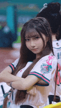 a girl wearing a shirt that says ' fisher ' on the sleeve