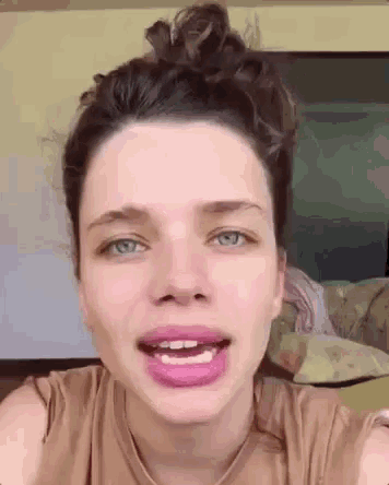 a close up of a woman 's face with pink lips