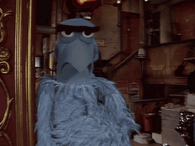 a blue bird is standing in front of a red sign that says fire
