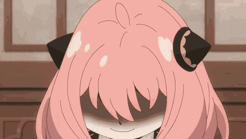 a close up of a pink haired anime girl with her eyes closed .