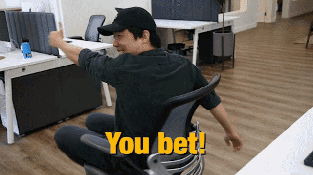 a man sitting in an office chair with the words you bet written on the floor