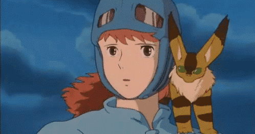 a girl in a blue helmet stands next to a cat with green eyes