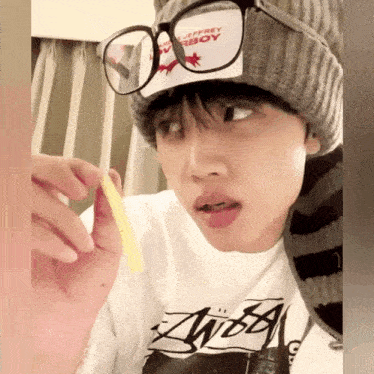 a person wearing glasses and a hat that says jeffrey boy