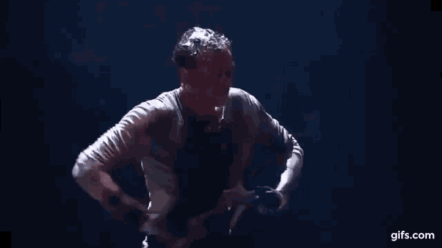a man and woman are dancing in a dark room .