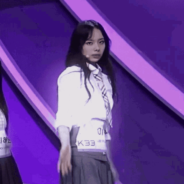 a girl in a white shirt with k33 on the back