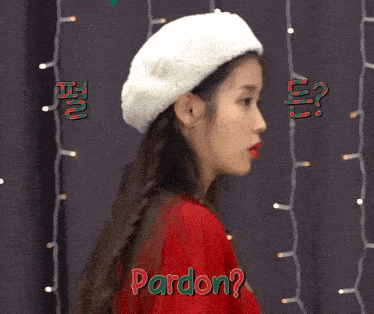 a woman wearing a red sweater and a white hat is asking for forgiveness
