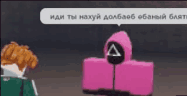 a man in a green shirt is standing next to a pink squid game player .