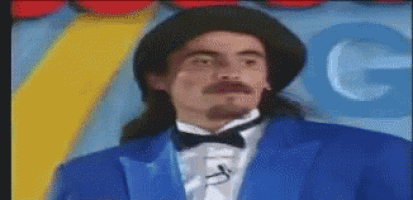 a man in a tuxedo with a mustache and a hat