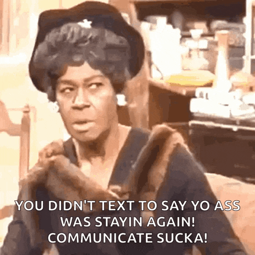 a woman is sitting at a table with a fur coat on her shoulder and says you did n't text to say yo ass