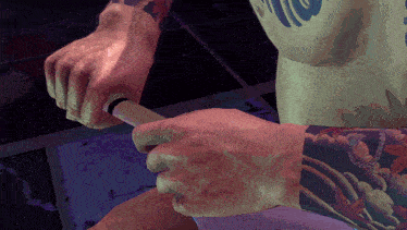 a man with a tattoo on his arm holds a sword