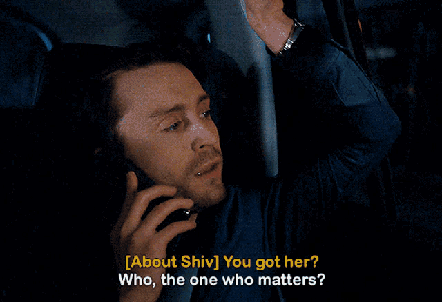 a man in a car is talking on a cell phone and says about shiv you got her who the one who matters