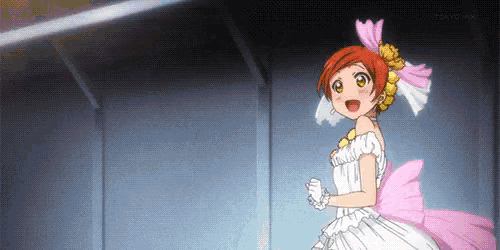 a girl in a white dress with a pink bow on her back is standing in a dark room .