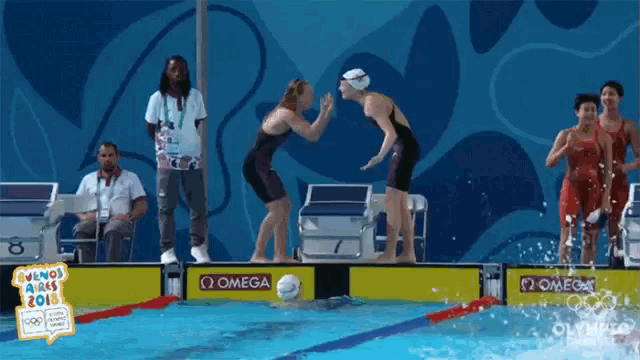 a swimming pool with a sign that says omega
