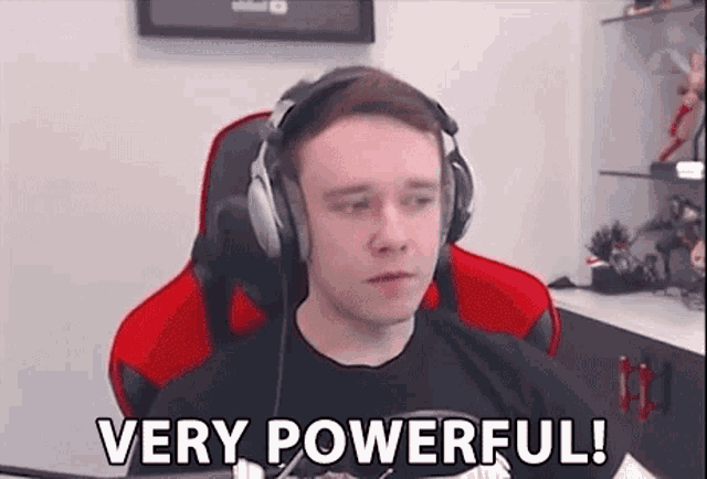 a man wearing headphones and a black shirt is sitting in a red chair and saying `` very powerful '' .