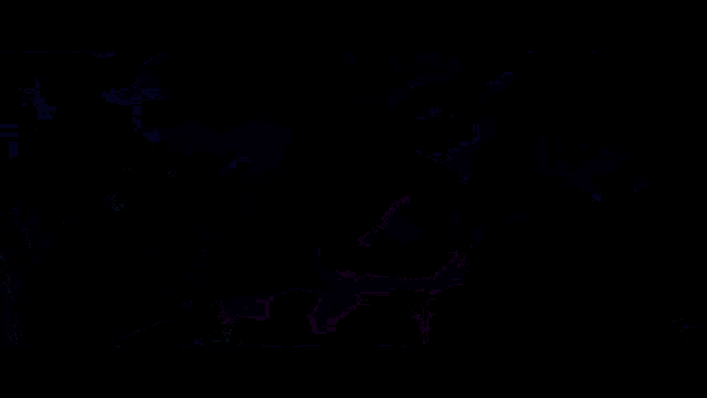 a man in a black coat is standing in a dark room with a lot of lights .