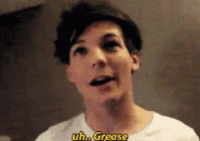 a young man is making a funny face and saying uh . grease .