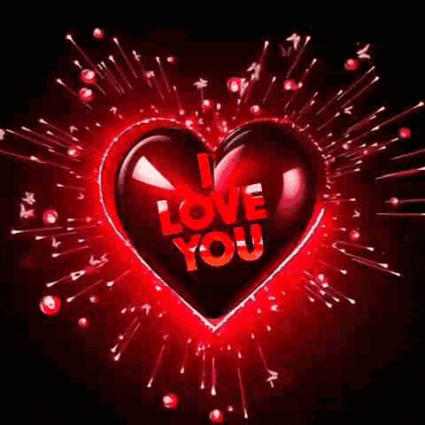 a red heart with the words `` i love you '' written inside of it surrounded by fireworks .