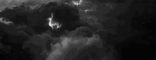 a black and white photo of lightning strikes in a dark cloudy sky .