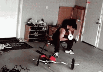 a man is sitting on a bench lifting a barbell .