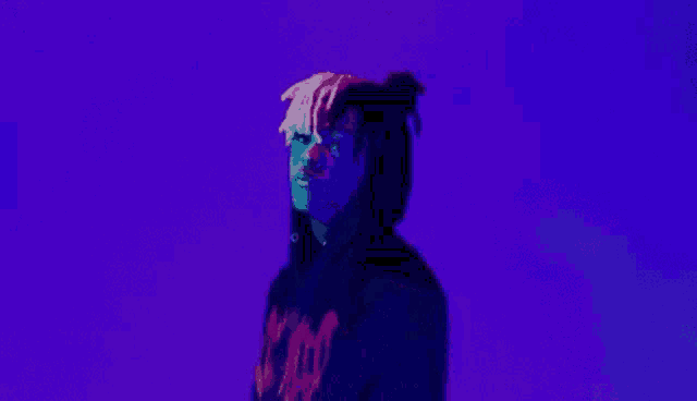 a man in a black hoodie is making a peace sign with his hands .